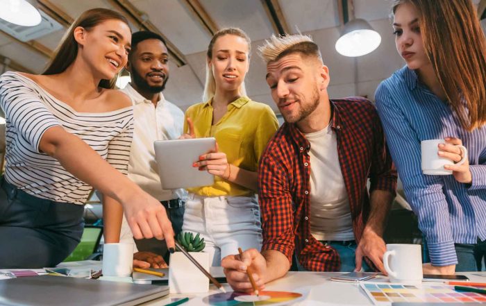 Creative team brainstorming marketing strategies at a Detroit agency focused on revenue generation.